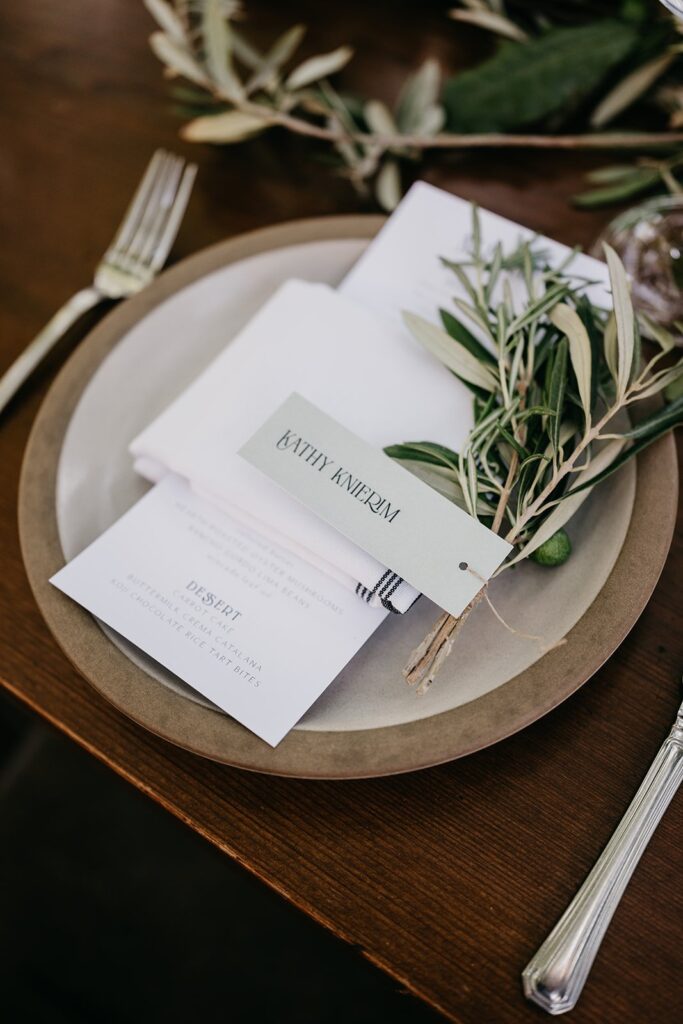 place setting with olive spring at luxury wedding 