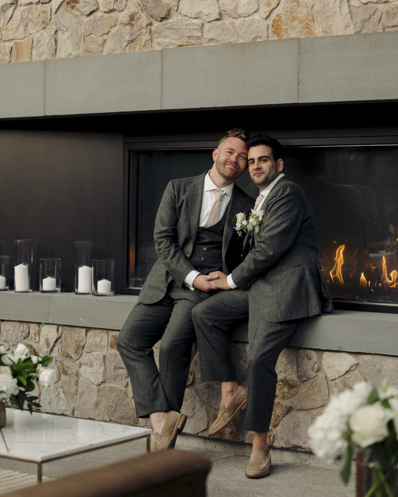 photo of grooms holding each other during reception 