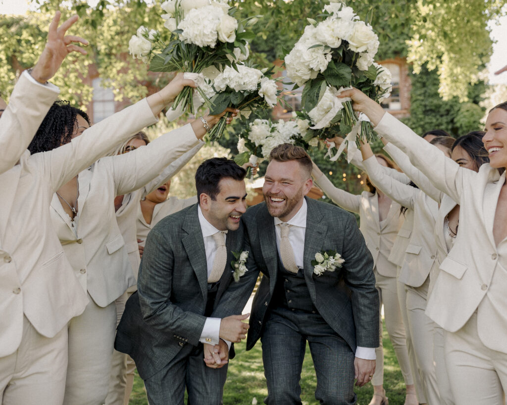 wedding party photos with grooms running through line of people