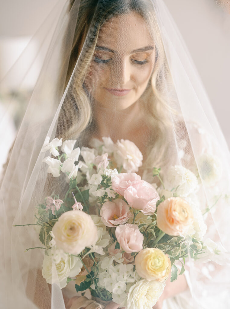 bride holding wedding flowers during getting ready photos