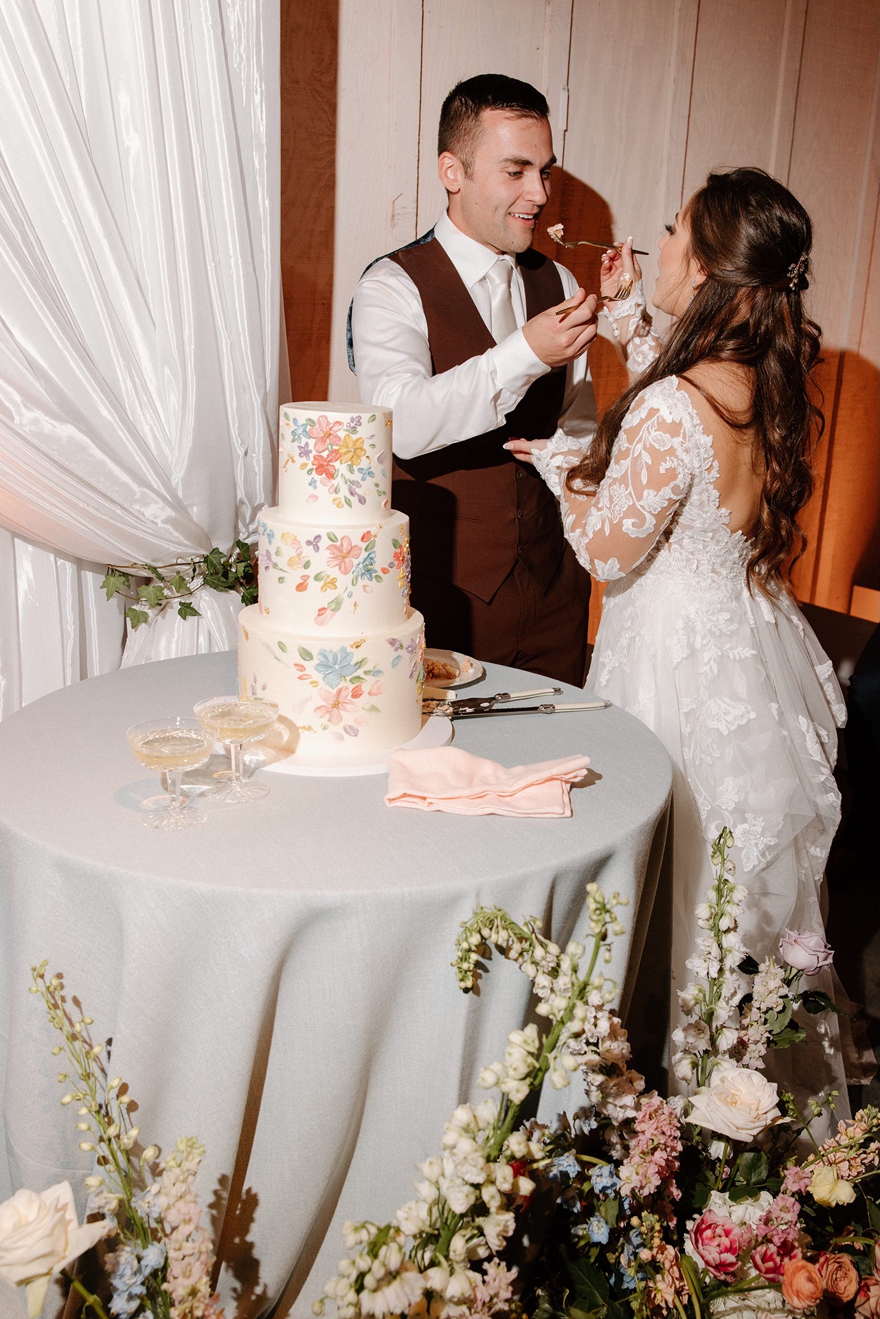 Bride and groom cutting cake at Harrow Cellars wedding reception